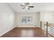 Spacious living room with wood floors and large window offers plenty of natural light at 875 Waterbrook Ct, Roswell, GA 30076