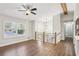 Bright living room features wood floors, large windows with shutters, and open floor plan at 875 Waterbrook Ct, Roswell, GA 30076