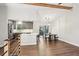 Open floorplan with wood-look floors, modern kitchen, stainless appliances, and a dining table near the deck at 875 Waterbrook Ct, Roswell, GA 30076