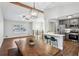 Open-concept living room with a beamed ceiling, dining area and a modern kitchen at 875 Waterbrook Ct, Roswell, GA 30076