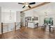 Open-concept living space with wood floors, ceiling fan, and eat-in kitchen with stainless steel appliances at 875 Waterbrook Ct, Roswell, GA 30076
