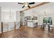 Open-concept living space featuring wood-look floors, modern lighting, and a view of the updated kitchen at 875 Waterbrook Ct, Roswell, GA 30076