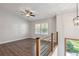 Spacious loft featuring wood floors, large windows, modern railing, and ample natural light at 875 Waterbrook Ct, Roswell, GA 30076
