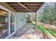 Cozy covered patio area leading to a grassy backyard and lush greenery, offering a serene outdoor space at 875 Waterbrook Ct, Roswell, GA 30076