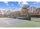 Community tennis courts with well-maintained surfaces, surrounded by fencing and landscaping at 875 Waterbrook Ct, Roswell, GA 30076