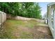 A spacious backyard area featuring lush greenery and a wood fence for privacy at 1031 Abercorn Way, Douglasville, GA 30134