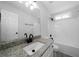 Bright bathroom featuring a granite countertop, sleek fixtures, and a modern shower-tub combo at 1031 Abercorn Way, Douglasville, GA 30134