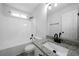 Bathroom with modern vanity, granite countertops, and a combined tub and shower at 1031 Abercorn Way, Douglasville, GA 30134