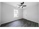 Cozy bedroom with a ceiling fan and large window for natural light at 1031 Abercorn Way, Douglasville, GA 30134