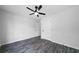 Spacious bedroom with wood-look tile flooring, a ceiling fan, and ample natural light at 1031 Abercorn Way, Douglasville, GA 30134