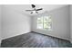 Bedroom showcasing dark hardwood floors, a ceiling fan, and a bright window at 1031 Abercorn Way, Douglasville, GA 30134