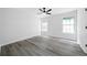 Spacious bedroom featuring sleek hardwood floors and two bright windows at 1031 Abercorn Way, Douglasville, GA 30134