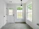 Bright kitchen featuring ample windows, access door, and modern tile flooring at 1031 Abercorn Way, Douglasville, GA 30134