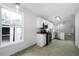 Kitchen featuring modern stainless steel appliances, sleek white cabinets, and a bright window at 1031 Abercorn Way, Douglasville, GA 30134