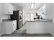 Bright kitchen featuring granite countertops, stainless steel appliances, and white cabinetry at 1031 Abercorn Way, Douglasville, GA 30134