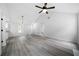 Open-concept living area with luxury vinyl plank flooring and modern ceiling fan at 1031 Abercorn Way, Douglasville, GA 30134
