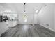 Open living area with white walls and luxury vinyl plank flooring and breakfast bar at 1031 Abercorn Way, Douglasville, GA 30134