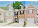 Charming townhome with brick facade, one-car garage, and well-maintained landscaping at 2457 Birkhall Way, Lawrenceville, GA 30043