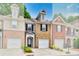 Charming townhome with brick facade, one-car garage, and well-maintained landscaping at 2457 Birkhall Way, Lawrenceville, GA 30043