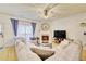 Cozy living room featuring a fireplace, ceiling fan, and lots of natural light at 2457 Birkhall Way, Lawrenceville, GA 30043