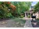Well-maintained backyard with a patio, grill, manicured garden beds, and privacy fence at 486 Milledge Gate Se Ter, Marietta, GA 30067