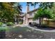 Expansive backyard with a screened porch, stone pathway, grill, and mature trees for shade at 486 Milledge Gate Se Ter, Marietta, GA 30067