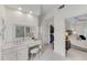 Bright primary bathroom with white cabinetry, vanity, stool, and walk-in closet at 486 Milledge Gate Se Ter, Marietta, GA 30067