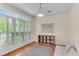Bright bedroom with hardwood floors, natural light from shuttered windows, and a cozy daybed at 486 Milledge Gate Se Ter, Marietta, GA 30067