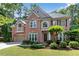 Charming two-story brick home with well-manicured lawn, lovely landscaping, and attached two car garage at 486 Milledge Gate Se Ter, Marietta, GA 30067