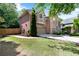 Traditional brick home with attached garage and a well-maintained lawn and landscaping at 486 Milledge Gate Se Ter, Marietta, GA 30067