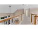 Bright hallway with wood railing overlooking a living room and a hallway leading to the bedrooms at 486 Milledge Gate Se Ter, Marietta, GA 30067