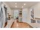 Kitchen with stainless steel appliances, granite countertops, and wood floors flows into breakfast nook at 486 Milledge Gate Se Ter, Marietta, GA 30067
