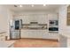 Kitchen features a stainless steel refrigerator, built-in oven and microwave, and ample counter space at 486 Milledge Gate Se Ter, Marietta, GA 30067