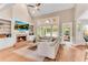 Open living room boasts a vaulted ceiling, fireplace, built-in shelves, and backyard views at 486 Milledge Gate Se Ter, Marietta, GA 30067