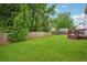A fenced backyard with a deck and plenty of green space at 5525 Mayfair Crossing Dr, Lithonia, GA 30038