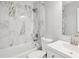 Bright bathroom featuring a shower over tub with elegant marble-style tile and a white vanity at 5525 Mayfair Crossing Dr, Lithonia, GA 30038