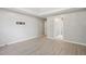 A bedroom with gray walls, hard floors, a walk-in closet, and an attached bathroom at 5525 Mayfair Crossing Dr, Lithonia, GA 30038