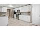A spacious kitchen featuring white cabinets, granite countertops, stainless steel appliances, and tile flooring at 5525 Mayfair Crossing Dr, Lithonia, GA 30038