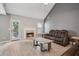 Cozy living room featuring a fireplace, leather couches, and a vaulted ceiling at 5525 Mayfair Crossing Dr, Lithonia, GA 30038