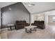 Spacious living room with vaulted ceilings, hard floors, modern ceiling fan, and neutral tones at 5525 Mayfair Crossing Dr, Lithonia, GA 30038