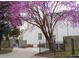 Charming home exterior with beautiful blooming tree, gated driveway, and well-maintained landscaping at 69 Randolph Ne St, Atlanta, GA 30312