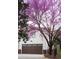 Home exterior featuring a garage door, landscaping, and purple flowering tree at 69 Randolph Ne St, Atlanta, GA 30312