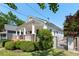 Charming white home with a manicured lawn, attractive fence and welcoming porch with brick pillars at 69 Randolph Ne St, Atlanta, GA 30312