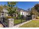 Charming white cottage-style house with black fence, green lawn, and inviting front porch at 69 Randolph Ne St, Atlanta, GA 30312