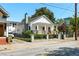 Exterior view of a white cottage-style house with a welcoming porch, well-kept lawn and paved driveway at 69 Randolph Ne St, Atlanta, GA 30312