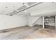 Spacious, unfinished garage with concrete flooring, white walls, shelving, utility sink, and overhead door at 69 Randolph Ne St, Atlanta, GA 30312
