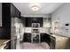 Well-equipped kitchen with stainless steel appliances and dark wood cabinets at 69 Randolph Ne St, Atlanta, GA 30312