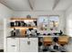Modern kitchenette area featuring white cabinets, black and white backsplash, and barstool seating at 69 Randolph Ne St, Atlanta, GA 30312