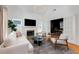 Bright living room featuring a cozy fireplace, stylish furniture, and a light hardwood floor at 69 Randolph Ne St, Atlanta, GA 30312