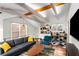 Bright living area with exposed wooden beams, hardwood floors, and stylish kitchenette at 69 Randolph Ne St, Atlanta, GA 30312
